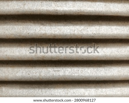 ​Corrugated galvanized metal sheet texture with subtle rust spots
