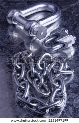 Galvanized straight shackle with steel chain on metal background