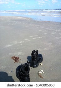 Galveston, Texas – September 22, 2017:  Steel-toed Boots Are Beached By A Houston Relief Worker For Toes In The Sand On A Rare Day Off In Galveston, One Of The Few Areas Spared By Hurricane Harvey.