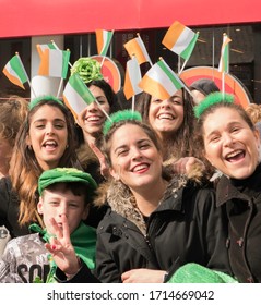 Galway City, Co.Galway, Ireland. March 17th, 2016. Groups Of Happy Onlookers On St Patricks Day In Galway, Ireland. Happy Children Waving Irish Flags And Face Paint, Cheering The Parade.