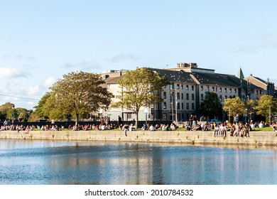 Galway City, Ireland - 18.08.2020: Young People Enjoy Sunny Weather By River Corrib, Galway City, Ireland. Spanish Arc Area. Famous For People Gathering