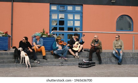 Galway, Ireland - 05 08 2013:
Musicians Play And Chat While Sitting On The Steps.
People Sit And Listen To Folk Music In The Back Of A Restaurant. Traditional Irish Music.