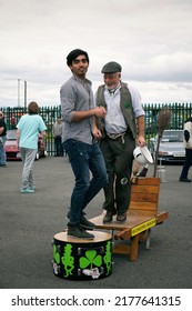 Galway, Ireland - July, 03. 2022: Old Bearded Man And Young Asian Man Dancing Irish Step Dance At Classic Fest 2022. 