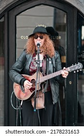 Galway, Ireland - July, 13. 2022: Musician, Busker, Playing His Guitar And Singing At Shop Street In Galway City Centre 