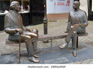 Galway, Ireland-April 10, 2018: Statues of writers Oscar  Wilde and Eduard Vilde. The statues by Tiiu Kirsipuu were unveiled in 1999 as a gift to Galway from the Estonian city of Tartu.