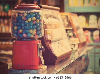 gamble eggs in vintage gumball machine on glass counter at grocery store, vintage filter effect