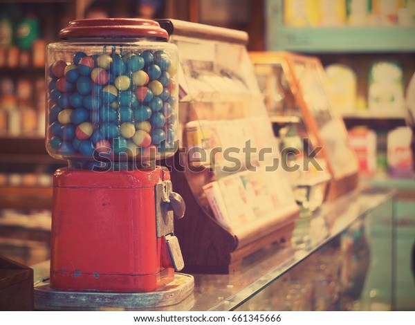 gamble eggs in vintage gumball\
machine on glass counter at grocery store, vintage filter\
effect