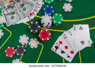 gamble. Poker concept.playing cards, chips and dollars are scattered around the new poker table.