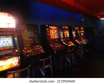 Gambling blurred background. Row of digital-based slot machines inside a casino, gambling club interior out of focus. Game of chance abstraction - Shutterstock ID 2173929469