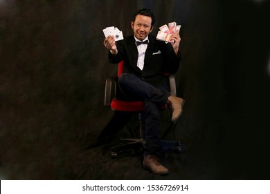 Gambling Casino Player Asian Man Holding Card And Money Rupiah