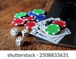 Gambling online bet concept , gamble dice, poker cards, casino  chips on laptop keyboard. 