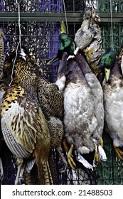 Game Birds Hanging, To Tenderize Them And Improve The Flavor, At A Butcher's Market Display.