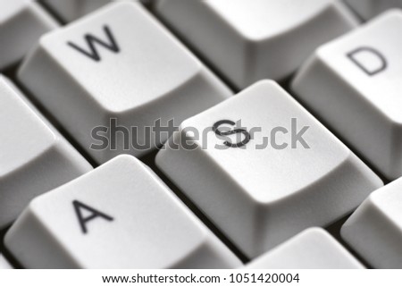 Game buttons A W S D on a white keyboard close-up for gamer