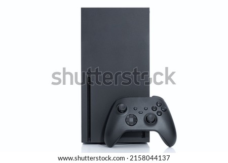 Game console and controller on white background.