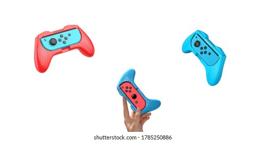 Game Console On Hand Isolated White Background. Red Blue Gaming Console. Wireless Game Controller