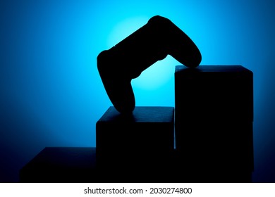 game controller on the steps out of boxes, background blue gradient from the center. controller silhouette