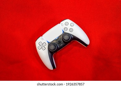 Game Controller Ps5 On Red Background.