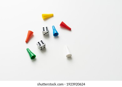 Game cubes, chips, hourglass on a white background. The concept of home Board games, classes at home with children, developmental training, logic games. Flatlay and space for text.