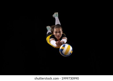 Game In Defense. Female Professional Fit Volleyball Player With Ball Isolated On Black Studio Background. The Athlete, Exercise, Action, Sport, Training, Fitness Concept. The Girl In Motion.