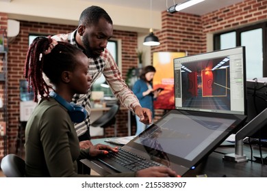 Game developing creative company employee working on videogame level design. Production department 3D artist team leader with multiple displays on desk working on digital entertainment project.