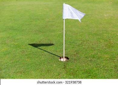 Game, Entertainment, Sport And Leisure Concept - Close Up Of Flag Mark In Hole On Golf Field