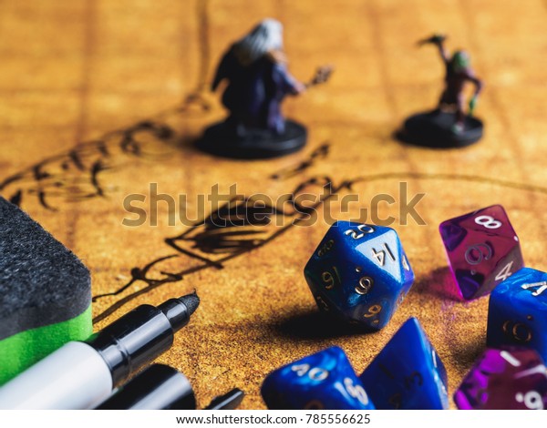 Game field of role playing party with dices\
and miniatures.
