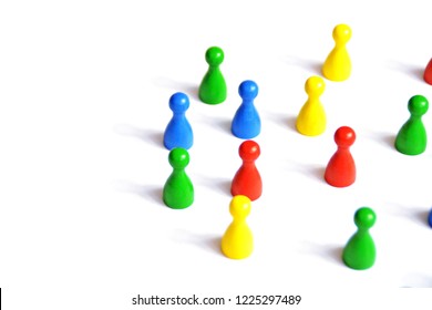 Game figures from a board game in different colors stand on a white background and throw all the shadows in one direction - concept with different figures on white background - Shutterstock ID 1225297489