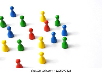 Game figures from a board game in different colors stand on a white background and throw all the shadows in one direction - concept with different figures on white background - Shutterstock ID 1225297525