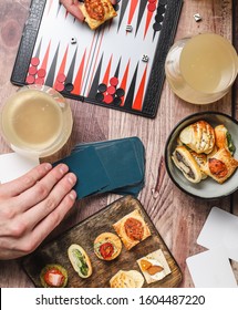 Game Night, Hands Playing Board Games Eating Finger Food And Drinking Kombucha