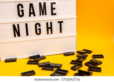 Game Night Text On Lightbox With Black Dominoes On Yellow Background, Table Game, Dominoes Flying
