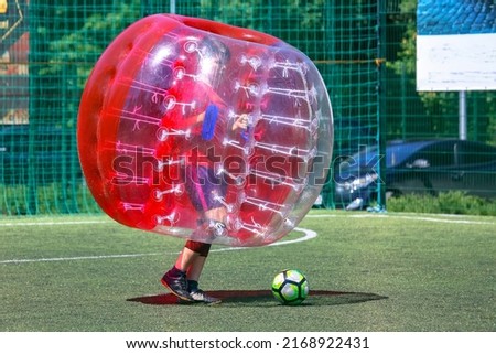 game on the field in transparent balloons. football ball game in inflatable transparent spheres. sports and entertainment. active recreation and hobbies