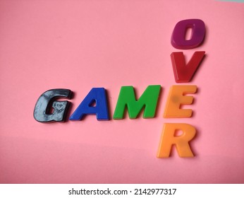 game over words isolated on pink background. Selected focus 