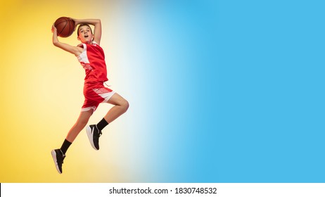 Game. Portrait of young basketball player in uniform on gradient studio background. Teenager confident practicing with ball. Concept of sport, movement, healthy lifestyle, ad, action, motion. Flyer - Powered by Shutterstock