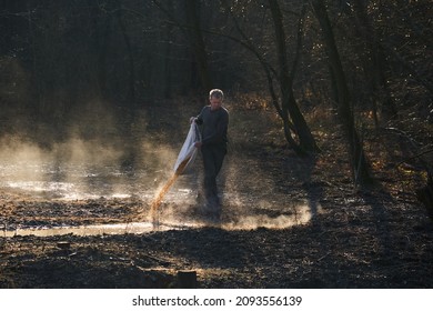 Game Ranger Spilling Maize On The Ground At Animals Feeding Spot