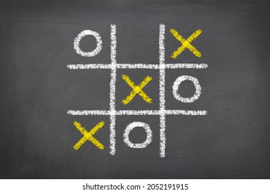 A game of tic tac toe played on a chalk board shows the need to be a critical thinker in the world of gaming. - Shutterstock ID 2052191915