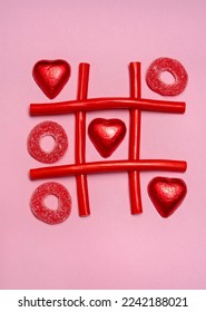 Game tic-tac-toe from sweet candy and chocolates hearts on pink background. Valentine's day. Holiday background - Shutterstock ID 2242188021