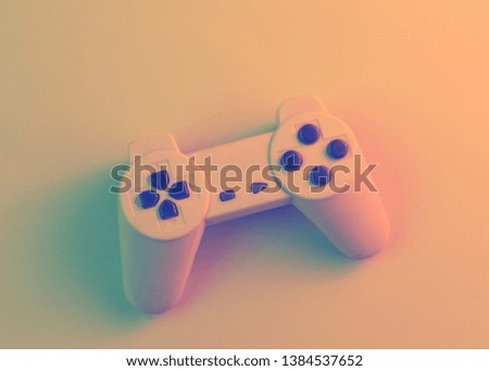 Gamepad with headphones. 80s. Retro wave, red green neon light, ultraviolet. Top view, minimalism