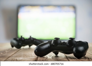 Gamepads on the table - Shutterstock ID 680705716