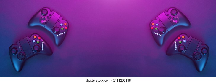 Gamepads on violet table background. Gamer concept.