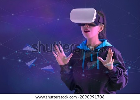 Gamer asian girl with handsup touching icon in the air and wearing VR glasses or virtual reality glasses ,Virtual reality with esport concept