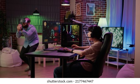 Gamer Girl Shocked After Losing Action Space Simulation Game While Boyfriend Is Playing Virtual Reality First Person Shooter At Home. Couple In Online Gaming Competition Using Pc And Vr Goggles.