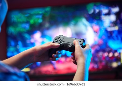 Gamer holding Gamepad, Controller or Videogame Joystick Console in hands. Close up, game concept - Shutterstock ID 1696680961