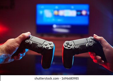 Gamer holding Gamepad, Controller or Videogame Joystick Console in hands. Close up, game concept - Shutterstock ID 1696680985