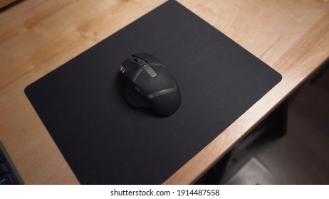 Gamer Mouse In Black Color With Several Buttons, On Black Mousepad