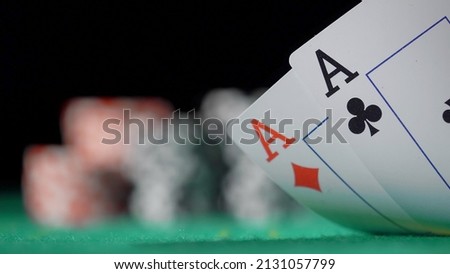 Gamer person playing poker in casino. Betting chips stacks. Call and raise. Card game on green table. Gambling. Texas Hold'em. Dealer and gambler, fortune. Two aces pair.