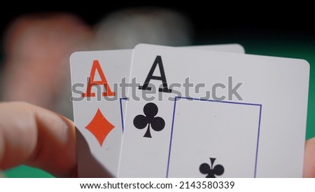 Gamer person playing poker in casino. Betting chips stacks. Call and raise. Card game on green table. Gambling. Texas Hold'em. Dealer and gambler, fortune. Two aces pair.