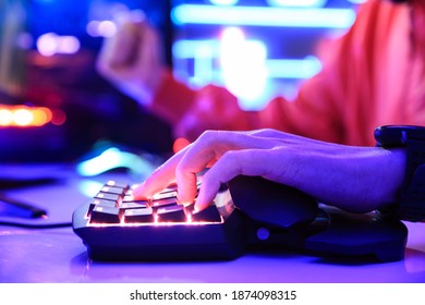 Gamer playing online game on PC in dark room. - Shutterstock ID 1874098315