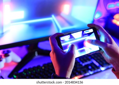 Gamer Playing Online Game Via Smart Phone In Dark Room