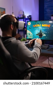 Gamer Playing Video Games With Controller And Vr Headset. Player Winning Game While He Uses Joystick And Virtual Reality Glasses On Computer. Gamer Feeling Happy About Online Win.
