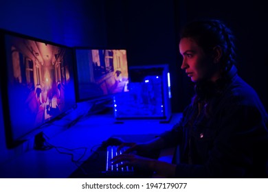 The gamer plays on the computer in online shooters with neon light. Stream, e-sports. Games - Shutterstock ID 1947179077